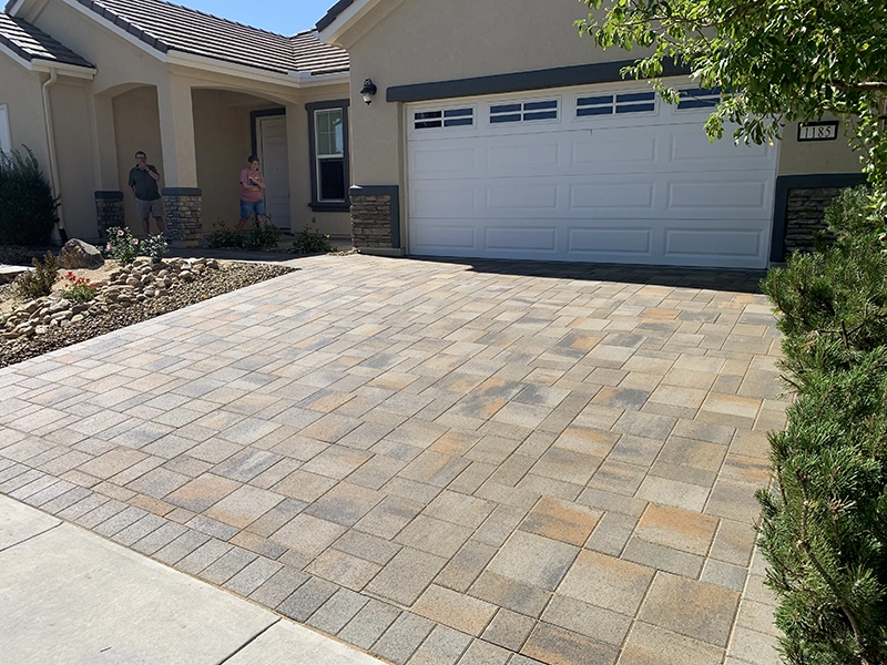 A custom, brick driveway built by the driveway pavers at Elite Hardscapes & Landscapes.